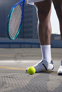 在屋顶球场打球的网球运动员图片
