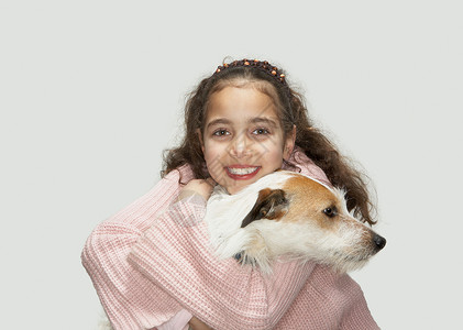 抱着小猎犬的女孩背景图片