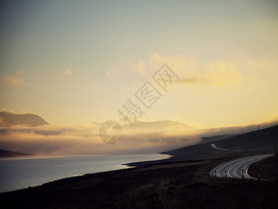 英国苏格兰西北高地黄昏时蜿蜒的道路和湖泊景色图片