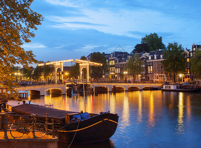 运河圣马丹荷兰阿姆斯特丹，黄昏时分照亮的“瘦桥”背景