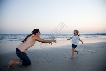 在海滩上向母亲跑去的女孩图片