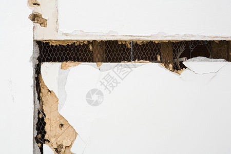 钢丝网损坏的石膏板墙背景