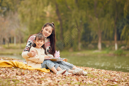 母女坐在草地上看书图片