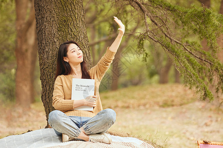 年轻女性树下看书图片