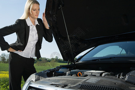 汽车发动力女人查看发生故障的汽车背景