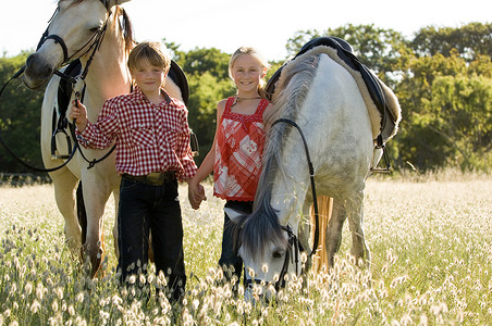 牵着马的男孩和女孩图片