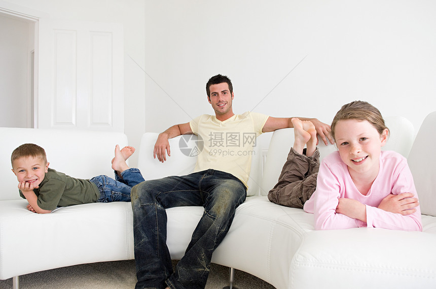 父亲带着孩子坐在沙发上图片