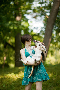 抱着宠物小猎犬的女人图片