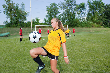 足球衫练习足球技能的女孩背景
