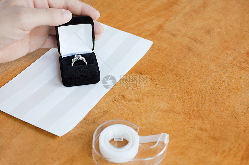 拿着订婚戒指的人图片