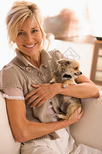 怀里抱着一只小狗的女人图片