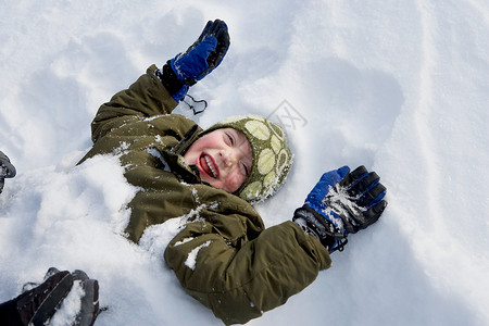 小男孩躺在雪地里图片