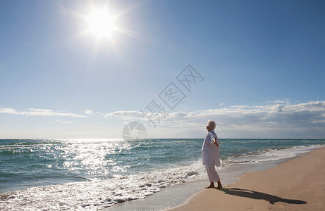 海滩晒太阳人海滩上的老太太背景