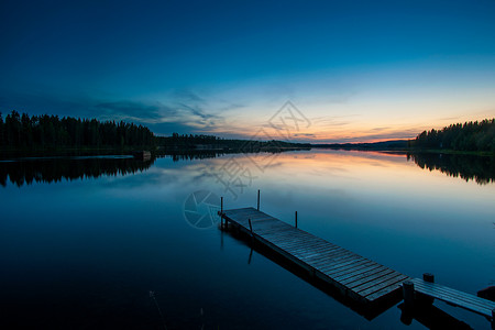 瑞典拉普兰斯凯尔夫特岛黎明时分的湖和木码头背景图片