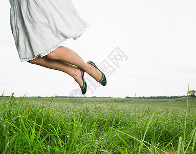 草地里跳跃的女人图片