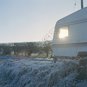 雅思兰黛在霜冻的早晨阳光照射的有窗户的大篷车背景