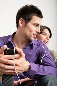 微笑的情侣带耳机听音乐图片