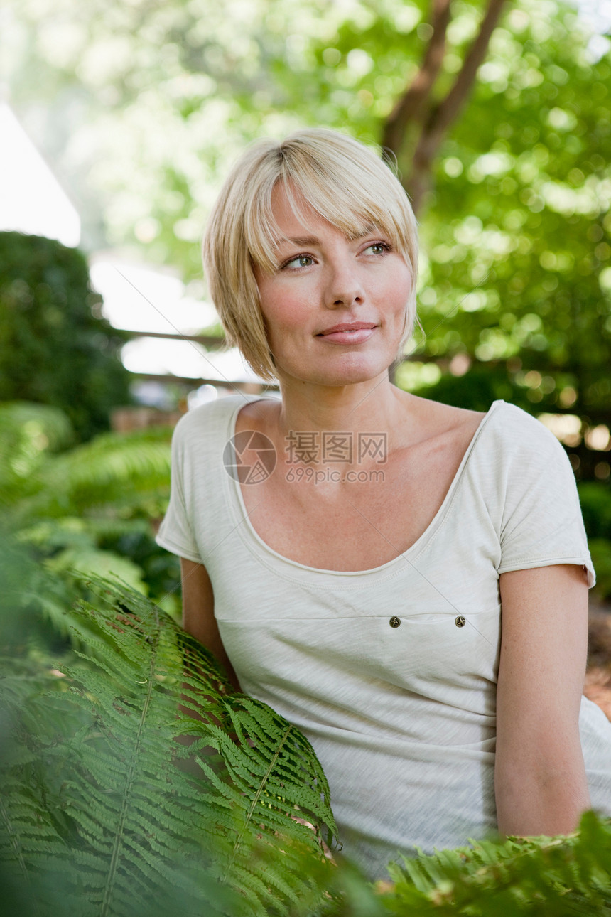 坐在花园里的年轻女子图片