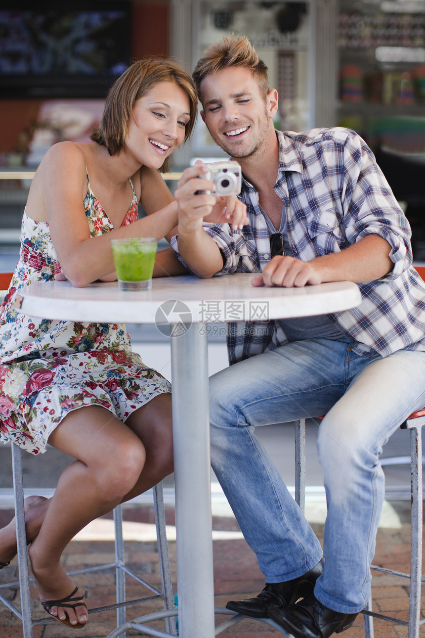 情侣在咖啡馆欣赏照片图片