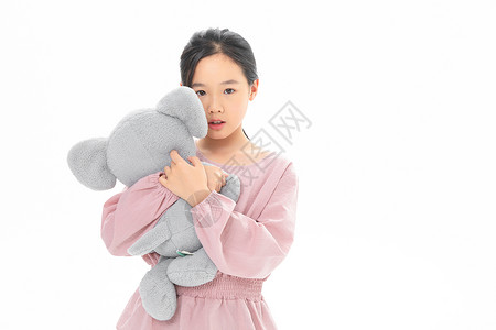 抱考拉难过的女孩抱着玩具小象背景