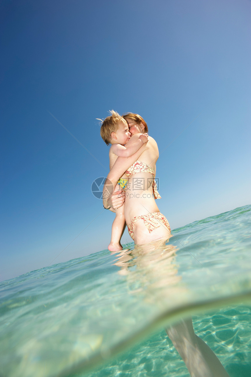 在水中抱着孩子的女人图片