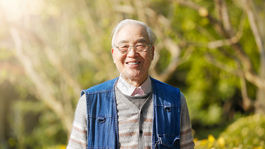 阳光下的眼镜老年男人微笑形象背景