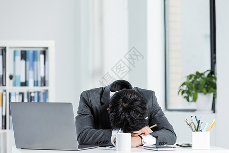 商务男性办公室趴在桌子上休息高清图片