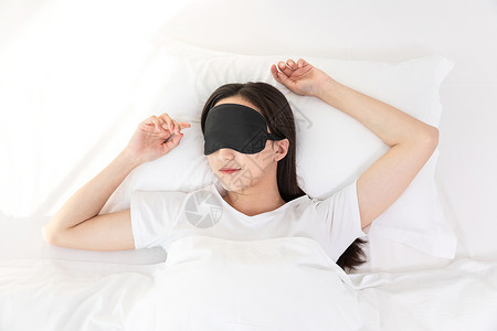 戴眼罩的人居家青年女性戴着眼罩睡觉背景