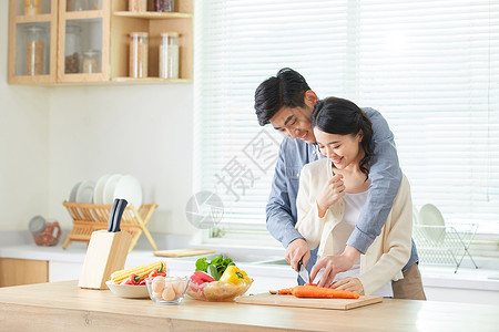 甜蜜卡通七夕年轻夫妻在厨房一起备菜背景