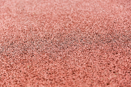红色磨砂背景橡胶跑道特写背景