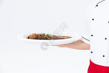 厨师手捧红烧鱼菜品特写背景