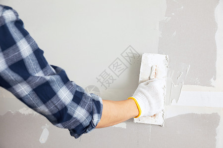 工人刷墙装修工人擦墙腻子手部特写背景
