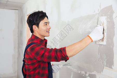 刷墙施工装修工人涂擦墙腻子刷墙背景