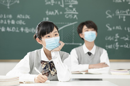 戴口罩上课的女孩戴口罩写作业的中学生背景