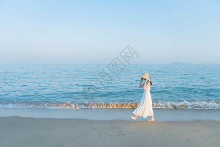 唯美白色沙滩散步的欢快活泼美女背景
