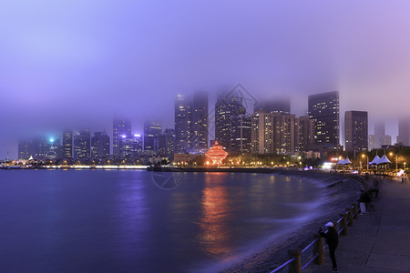 市南区青岛海滨城市雾气中夜景背景