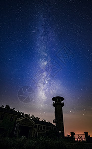 夜晚星空银河与古老的建筑房屋图片
