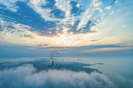 朝阳海岸航拍清晨云雾之中的城市青岛背景