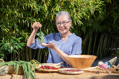 端午节奶奶户外包粽子图片