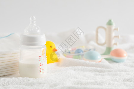 母婴用品艺术字新生儿奶瓶和玩具背景
