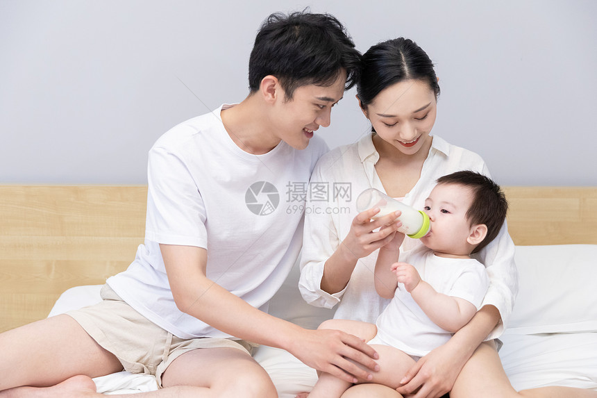一家三口爸爸妈妈喂婴儿喝奶图片