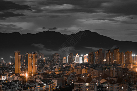 黑金风格山下的城市背景图片