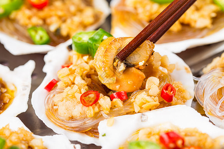 牡蛎肉筷子夹起扇贝肉背景