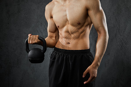 运动壶使用壶铃健身的运动男性背景