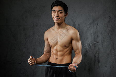 中国腹肌素材运动男性拉力绳训练背景