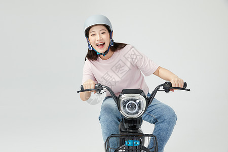 一盔一带安全知识宣传栏青年女性戴头盔骑电动车背景