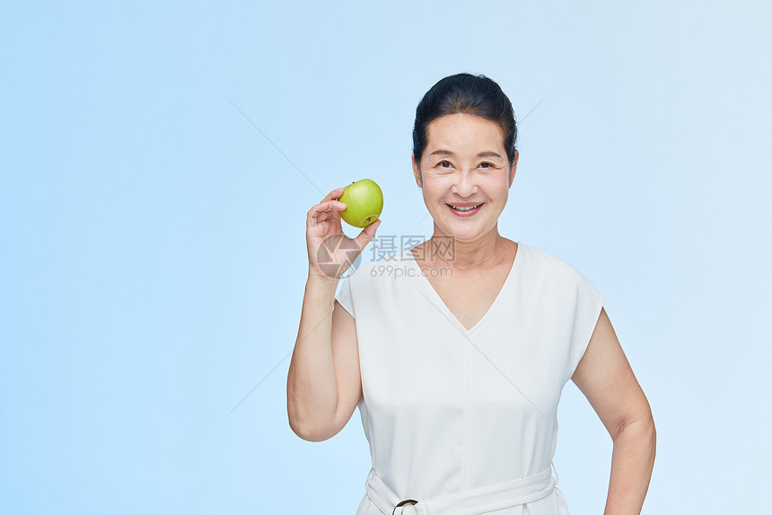 老年女性手拿苹果展示图片