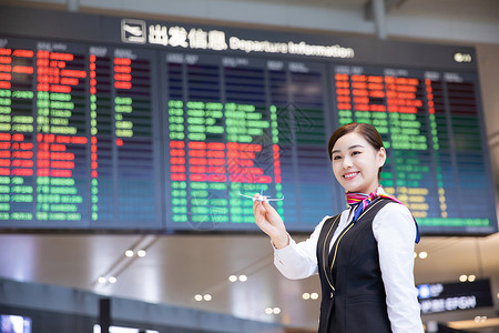 机场空姐拿飞机模型背景图片