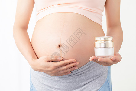 预防妊娠纹孕妇手拿润肤乳背景