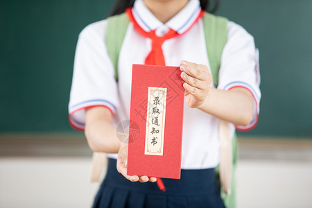 学校励志标语手捧录取通知书的初中生背景